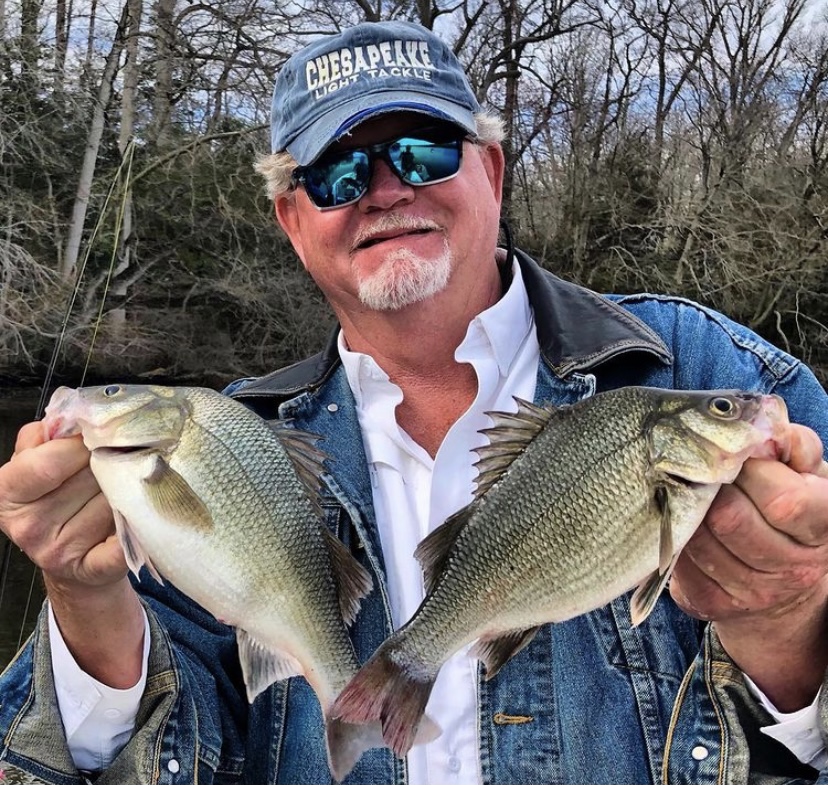 Fisherman holding two panfish