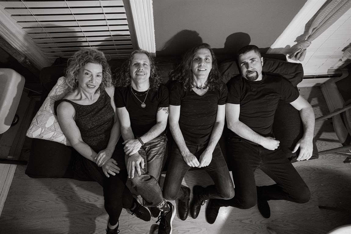 The Machine band sitting on couch Photo