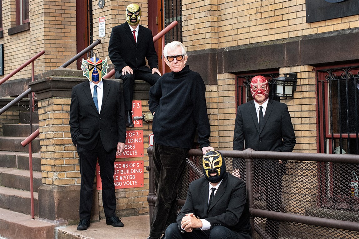 Nick Lowe & four people in Lucha Libre Mexican wrestling masks Photo