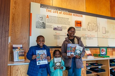 Three youth stand in the Visitor Center at the Josiah Henson Museum and Park Photo