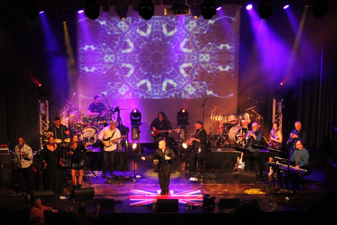 Phil Collins Experience Band Performing on a stage Photo