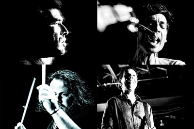 four people playing instruments Photo