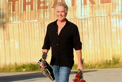 Shaun Cassidy holding a guitar and flowers Photo