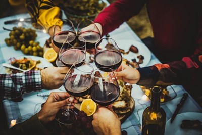 Group of friends holding wine glasses over a fall inspired table Photo
