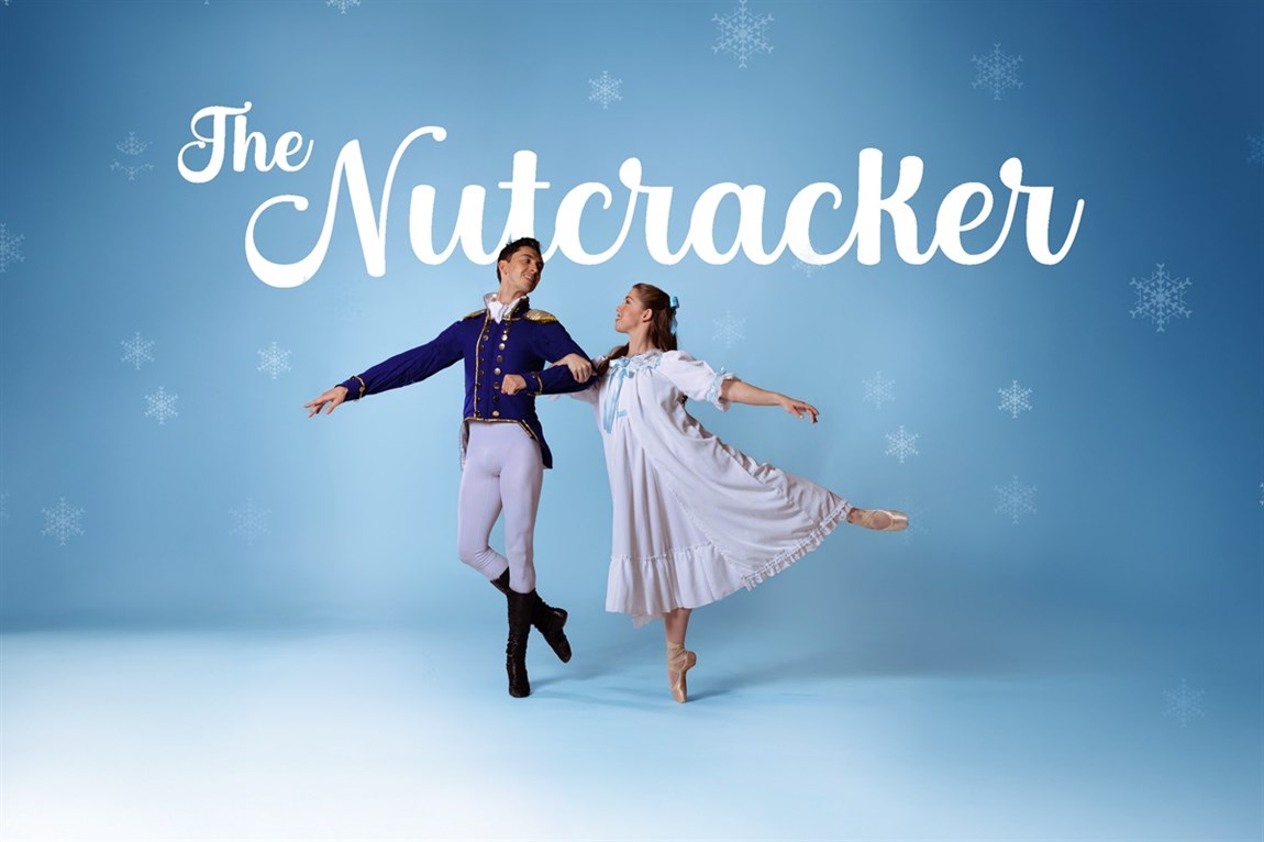 Two dancers posing with snowflakes in the background Photo