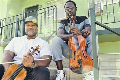 Black Violin duo sitting on stairs Photo