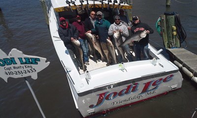 Picture of fishing party holding up their catch of Rockfish aboard the Jodi Lee Photo