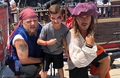 Two pirates and a young man aboard the Urban Pirates Ship Photo