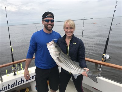 Man and woman with a fish Photo