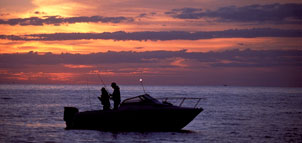 Boat on the water at sunset Photo
