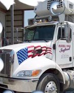 A refrigerated truck gets ready to deliver fresh seafood. Photo