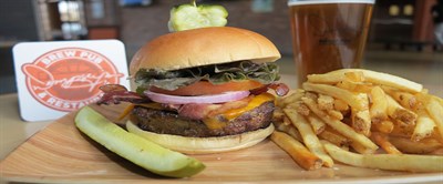 Loaded burger, fries and a pickle Photo