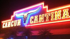 Cancun Cantina sign glows at night. Photo