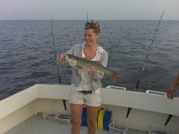 Angler proudly holding catch aboard Carlton Edwards Charter Photo