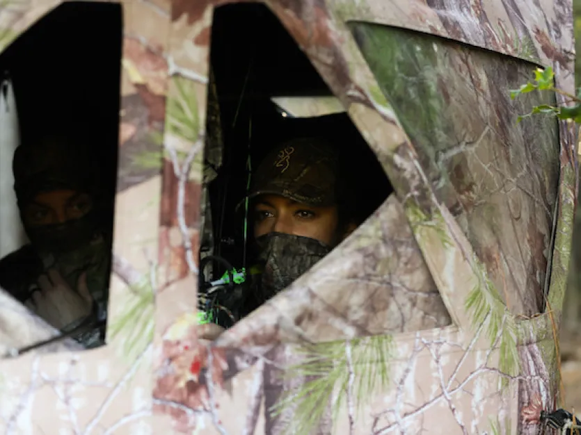 Hunters in a camouflaged box blind
