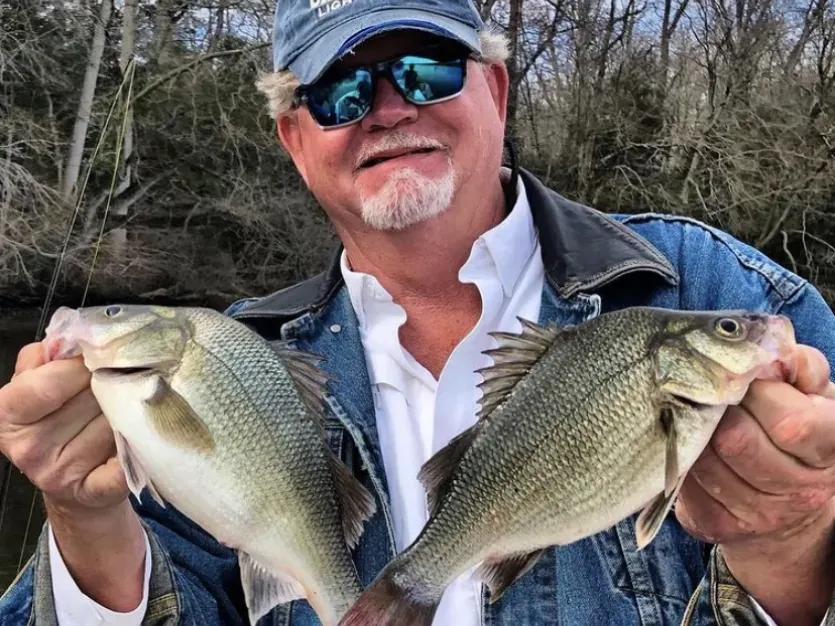Fisherman holding two panfish