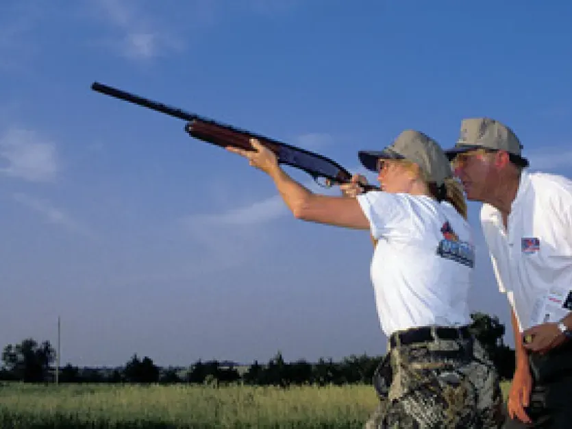 Instructor and student skeet shooting