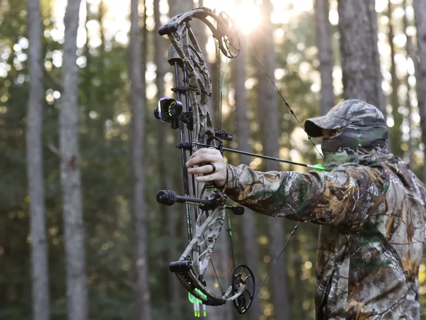 Archer hunting in full camouflage
