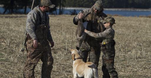 Family in camo with dog