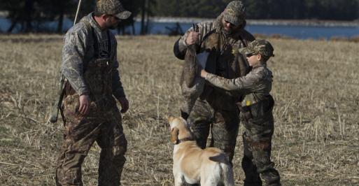 Family in camo with dog