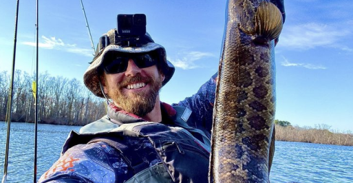 Fisherman holding a northern snakehead