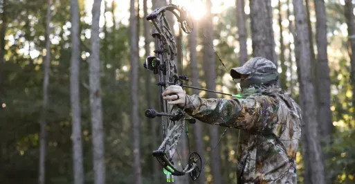 Archer hunting in full camouflage