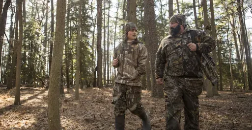 Father and Son in woods hunting