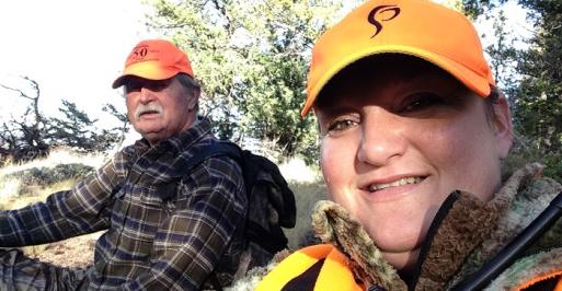 Man and woman pose for a selfie while hunting