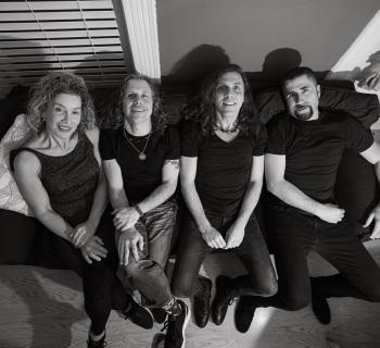 The Machine band sitting on couch Photo