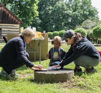 Three people engage in an outdoor activity Photo
