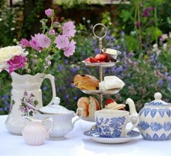 Tea and pastries set up on outdoor table. Photo