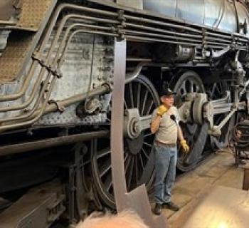A Museum volunteer giving a restoration shop tour. Photo