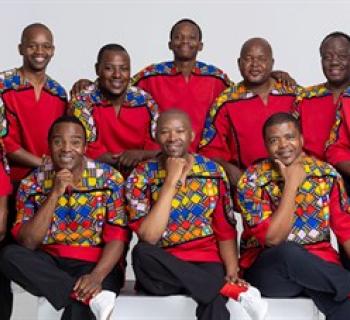 Ladysmith Black Mambazo wearing colorful red tunics. Photo