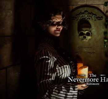 Victorian woman in the dark holding a candle in front a tomb  Photo