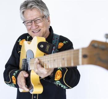 Richie Furay holding guitar Photo