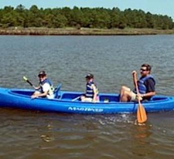 Father and children kayaking Photo