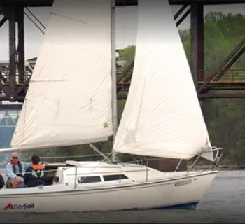 A group taking a sailing lesson on a white Bay Sail sailboat. Photo