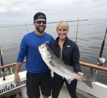 Man and woman with a fish Photo