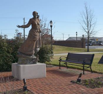 Statue of Harriet Tubman with historic marker nearby. Photo