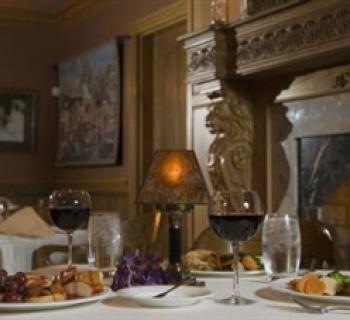 Romantic dinner for two by the fireplace. Photo