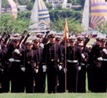 Midshipmen standing by water Photo