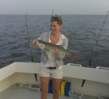 Angler proudly holding catch aboard Carlton Edwards Charter Photo