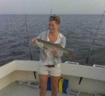 Angler proudly holding catch aboard Carlton Edwards Charter Photo