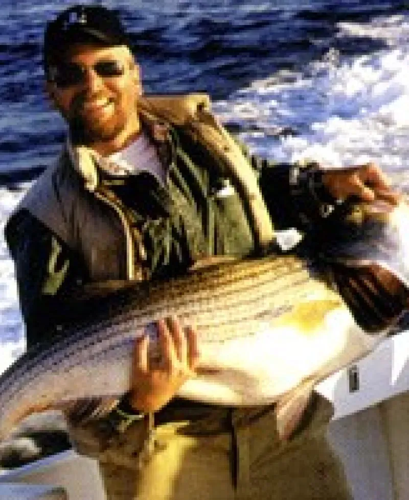Fisherman holding a rockfish Photo