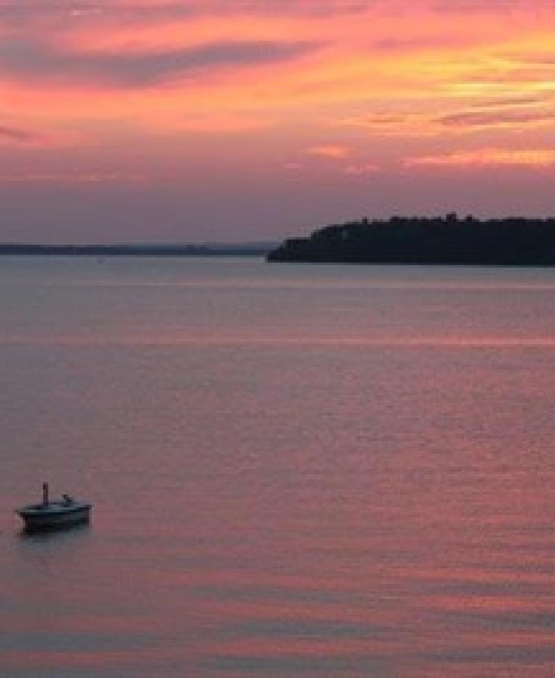 Crystal Beach at Sunset with small boat Photo