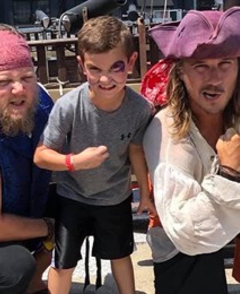 Two pirates and a young man aboard the Urban Pirates Ship Photo