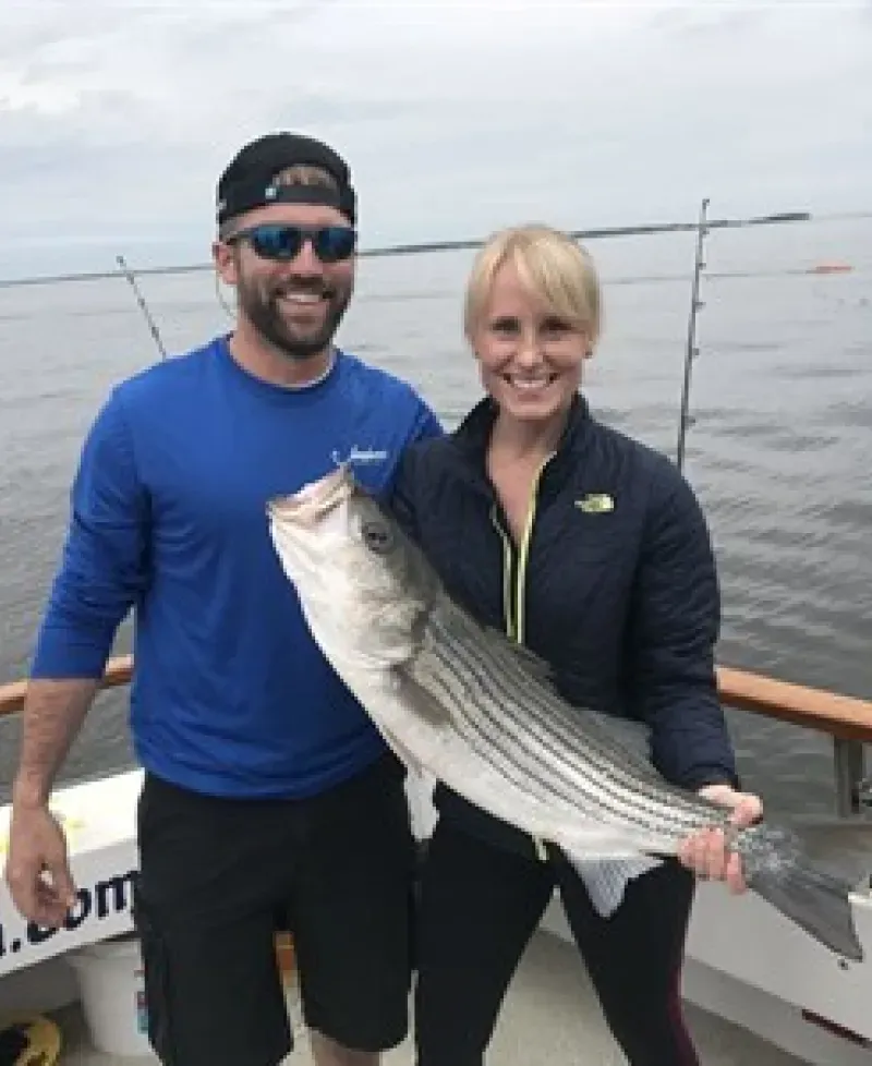 Man and woman with a fish Photo