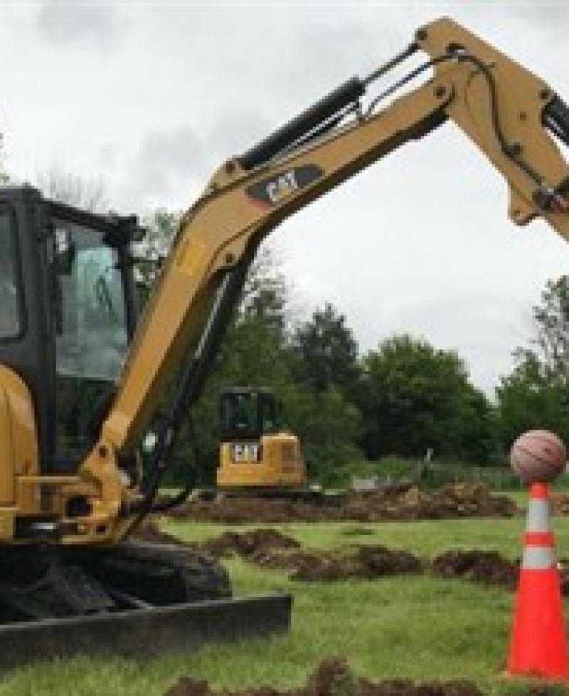 Track excavator with basketball Photo
