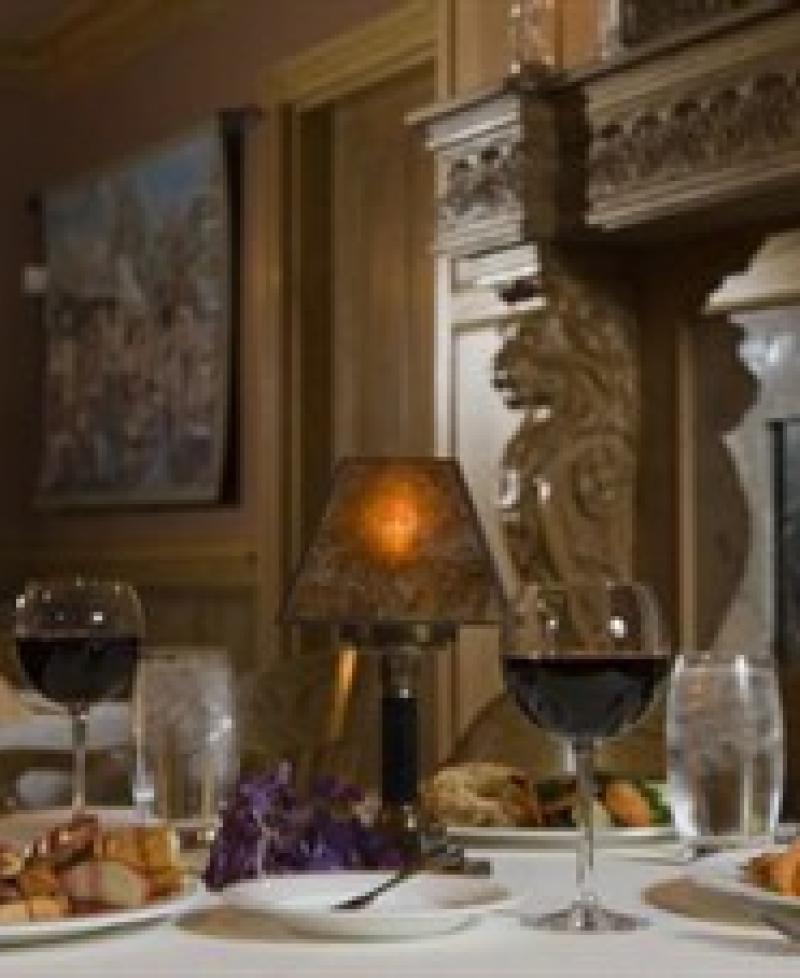 Romantic dinner for two by the fireplace. Photo