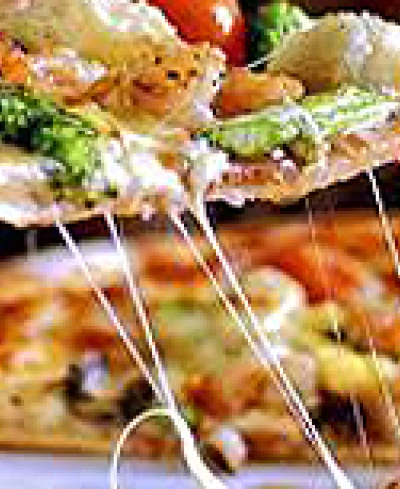 Slice of pizza being removed from a whole pizza Photo